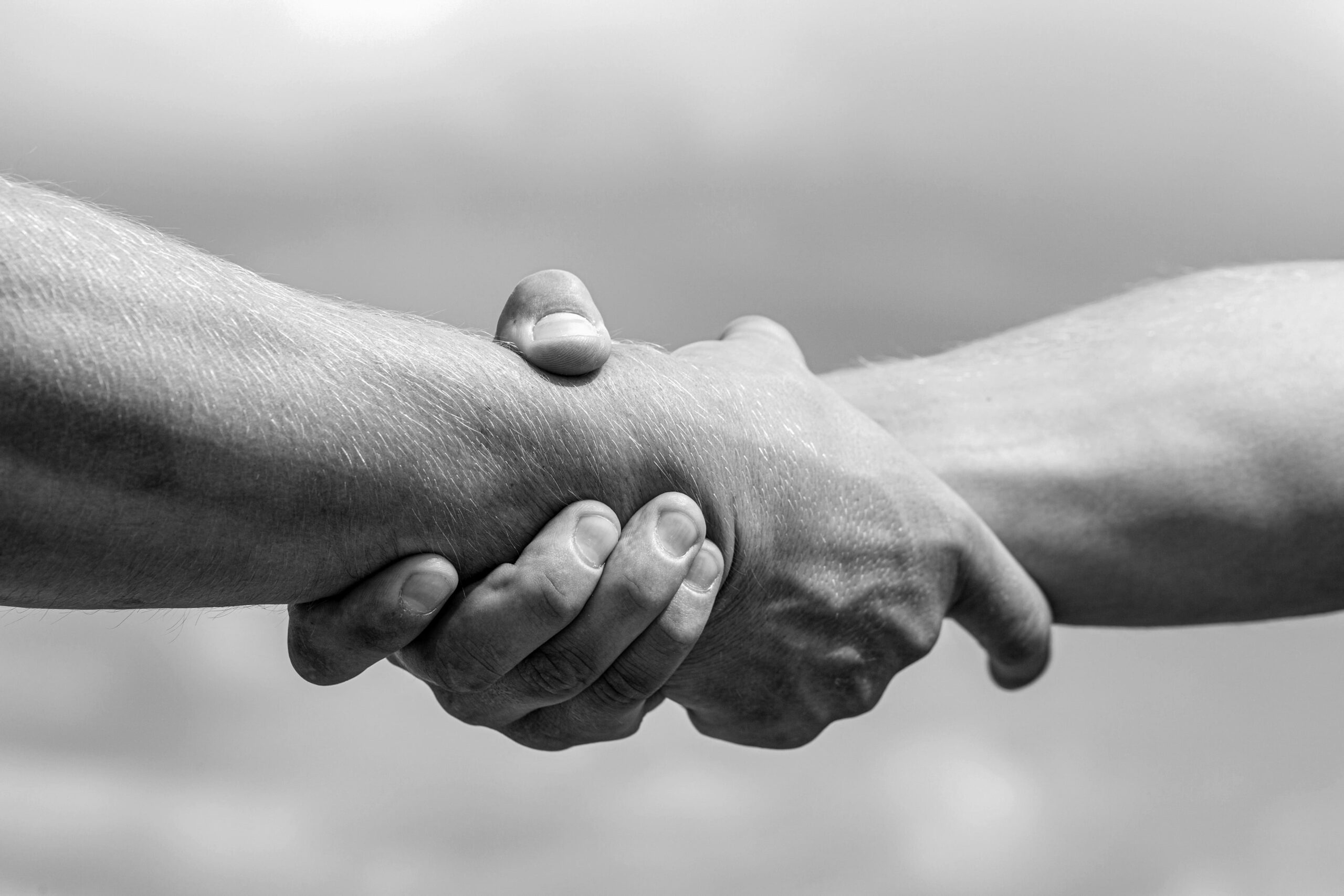helping-arm-hand-friend-teamwork-helping-hand-outstretched-arm-salvation-black-white (1) (1)
